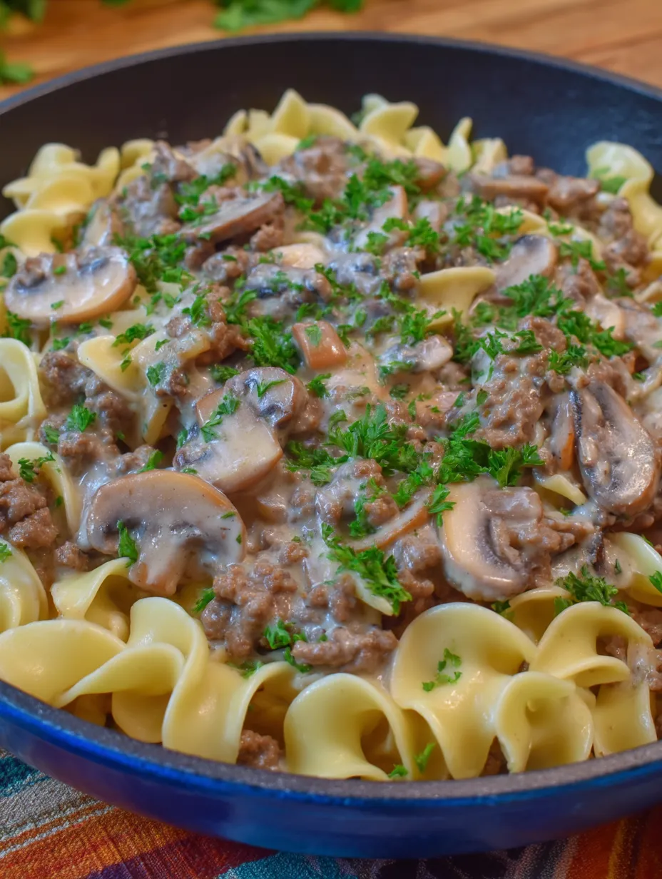 A plate of pasta with mushrooms and meat.