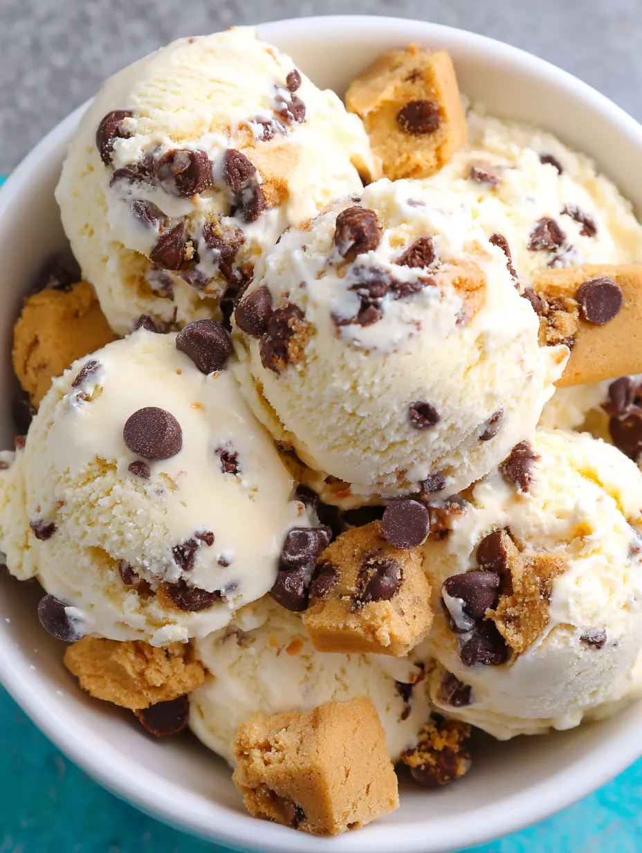 A bowl of ice cream with chocolate chips and cookies.