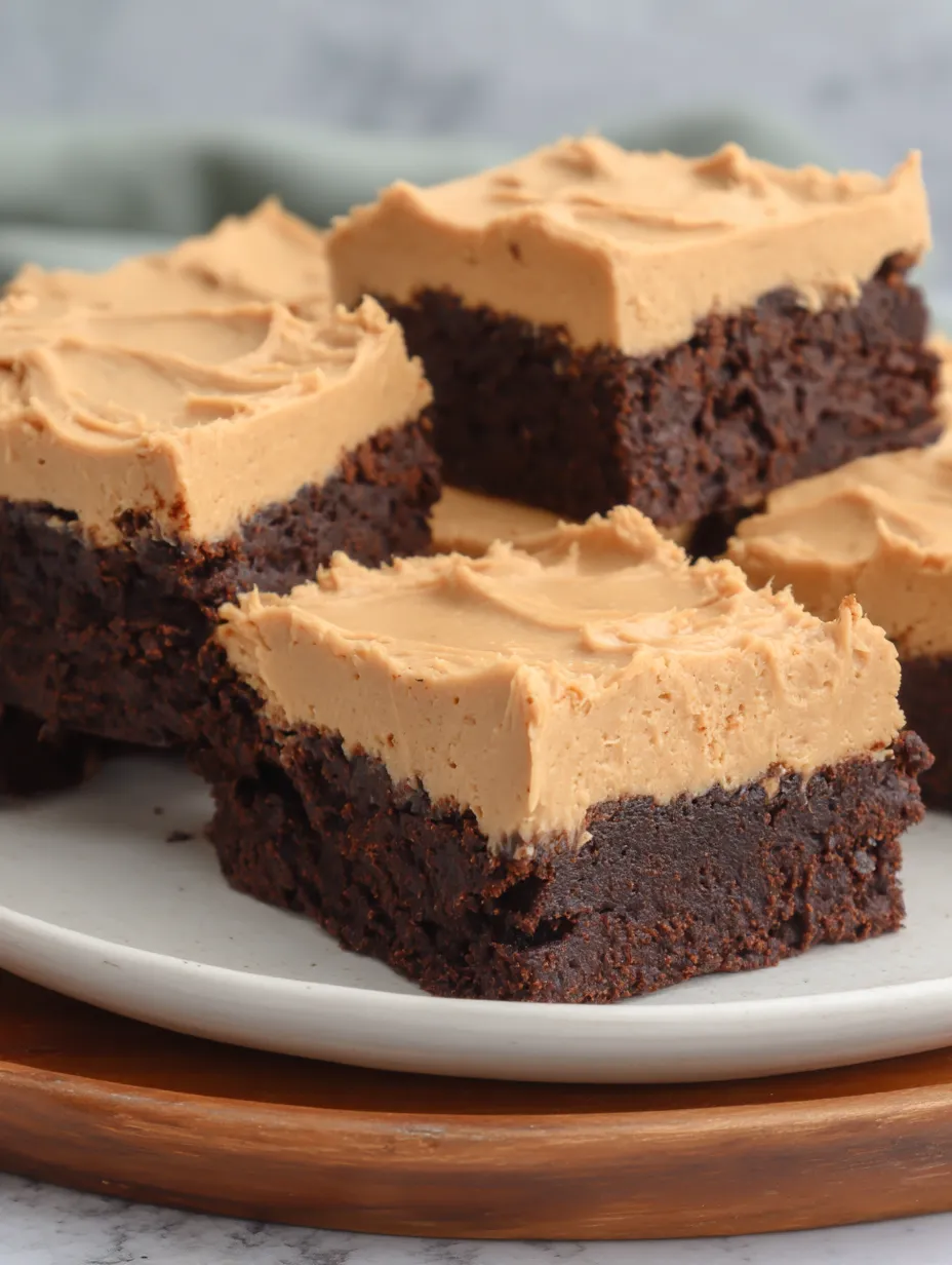 A plate of chocolate cake with peanut butter frosting.