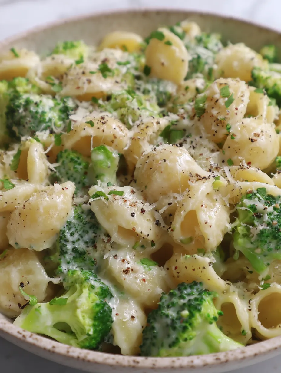 A bowl of pasta with broccoli.